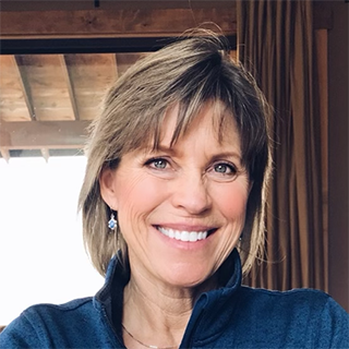 Author Teresa Ann Peter smiling in a blue shirt at home.